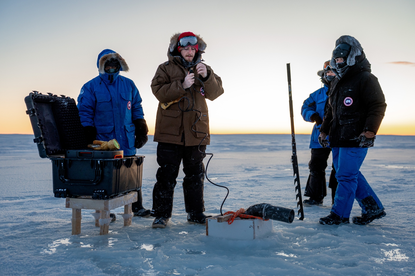 A group of people in warm jackets on the ice